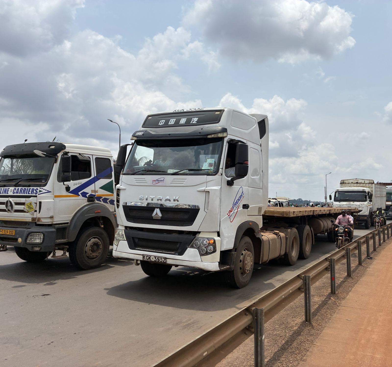 Heavy trucks on a Ugandan highway